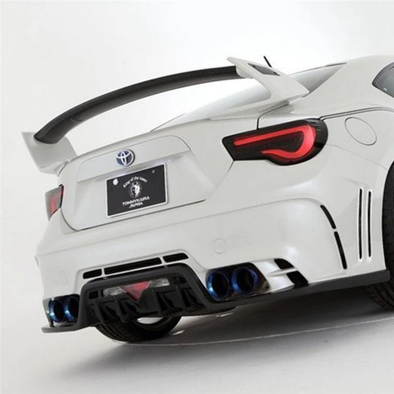 White car with a large rear wing and custom license plate on a white background
